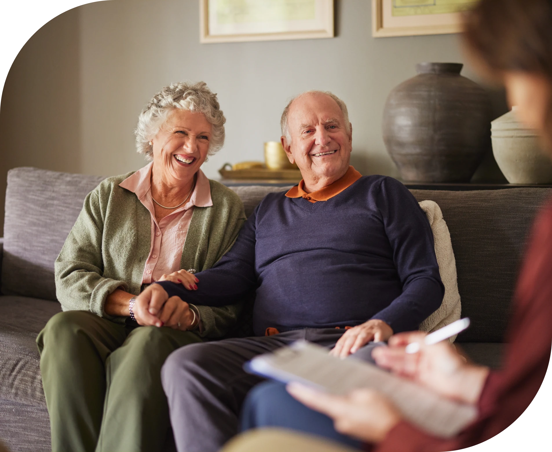 Older couple sitting on a couch, at each other